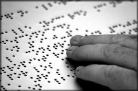 mano che legge un testo in braille